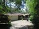 Back of brick home with attached garage, screened porch, and mature landscaping at 2448 Sherbrooke Ne Ct, Atlanta, GA 30345
