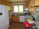 Kitchen with wood cabinets and bright window above the sink at 2448 Sherbrooke Ne Ct, Atlanta, GA 30345