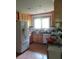 Kitchen with wood cabinets and bright window above the sink at 2448 Sherbrooke Ne Ct, Atlanta, GA 30345