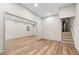 Finished basement with sleek wood-look floors, access to stairs, and ample open space at 5236 Forest Brook Pkwy, Marietta, GA 30068