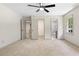 Carpeted bedroom with natural light and multiple access doors at 5236 Forest Brook Pkwy, Marietta, GA 30068
