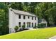 Side view of a two-story home featuring a white brick exterior and a well-maintained lawn at 5236 Forest Brook Pkwy, Marietta, GA 30068
