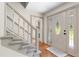 Inviting foyer with hardwood floors, a carpeted staircase, and an ornate front door with sidelights at 5236 Forest Brook Pkwy, Marietta, GA 30068
