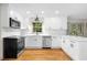 Bright kitchen featuring stainless steel appliances, white cabinets, and hardwood floors at 5236 Forest Brook Pkwy, Marietta, GA 30068