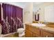 Bathroom featuring a shower with a decorative purple curtain, and a matching vanity with a round sink at 7057 Silver Bend Ovrlk, Austell, GA 30168