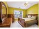 Bedroom with a decorative ceiling fan, large window for natural light, and matching furniture set at 7057 Silver Bend Ovrlk, Austell, GA 30168