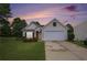 Charming single-story home with a well-manicured lawn, mature landscaping, and a two-car garage at 7057 Silver Bend Ovrlk, Austell, GA 30168
