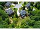 Beautiful homes nestled in a green, tree-filled community, showcasing the neighborhood's layout at 141 Olde Heritage Way, Woodstock, GA 30188