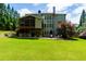 Beautiful backyard with a covered patio, outdoor bar, stone accents, and well-manicured lawn at 141 Olde Heritage Way, Woodstock, GA 30188