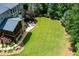 Large backyard featuring a screened-in porch, stone patio and mature landscaping at 141 Olde Heritage Way, Woodstock, GA 30188