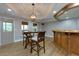 Entertaining bar area with wooden bar, wooden stools, and hardwood floors at 141 Olde Heritage Way, Woodstock, GA 30188