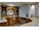 Traditional bar area with granite countertops and a sink at 141 Olde Heritage Way, Woodstock, GA 30188
