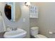 Elegant half bathroom with a modern sink and toilet at 141 Olde Heritage Way, Woodstock, GA 30188