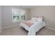 Comfortable bedroom with neutral decor and large window, complete with a cozy bed and carpeted floor at 141 Olde Heritage Way, Woodstock, GA 30188