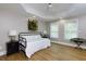 Bright bedroom with hardwood floors, tray ceiling, daybed, and natural light at 141 Olde Heritage Way, Woodstock, GA 30188
