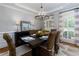 Charming dining area with a modern chandelier, wicker chairs, and bright natural light at 141 Olde Heritage Way, Woodstock, GA 30188