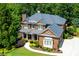 Beautiful exterior view of a brick home with a manicured lawn and lush landscaping at 141 Olde Heritage Way, Woodstock, GA 30188