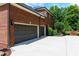 Brick home with a two-car garage and well-maintained landscaping at 141 Olde Heritage Way, Woodstock, GA 30188