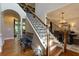 Elegant foyer with hardwood floors, staircase, and chandelier in the dining room at 141 Olde Heritage Way, Woodstock, GA 30188