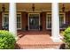 Inviting front porch featuring brick flooring and stylish outdoor decor at 141 Olde Heritage Way, Woodstock, GA 30188