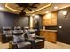 Home theater with comfortable seating and custom cabinets at 141 Olde Heritage Way, Woodstock, GA 30188