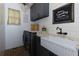 Charming laundry room with wainscoting, farm sink, modern appliances, and farmhouse decor at 141 Olde Heritage Way, Woodstock, GA 30188