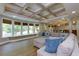 Spacious living room with coffered ceilings, hardwood floors, and many windows at 141 Olde Heritage Way, Woodstock, GA 30188