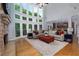Spacious living room with stone fireplace, hardwood floors and large windows offering scenic views at 141 Olde Heritage Way, Woodstock, GA 30188