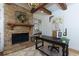 Bright office space with stone fireplace, wooden beams, built-in shelving and contemporary decor at 141 Olde Heritage Way, Woodstock, GA 30188