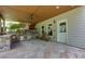 Covered patio featuring an outdoor kitchen and stone counter at 141 Olde Heritage Way, Woodstock, GA 30188