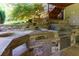 Outdoor stone kitchen with a built-in grill and stainless steel drawers at 141 Olde Heritage Way, Woodstock, GA 30188