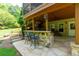 Outdoor patio with a built-in stone bar, seating, and access to the upper screened porch at 141 Olde Heritage Way, Woodstock, GA 30188