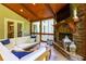 Comfortable screened-in porch with fireplace, TV and stylish furniture at 141 Olde Heritage Way, Woodstock, GA 30188