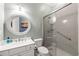 Clean bathroom featuring a shower, toilet, vanity with sink and a round mirror at 2412 St Davids Sq # 16, Kennesaw, GA 30152