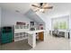 Bonus room features a ceiling fan, storage shelves, and large windows at 2412 St Davids Sq # 16, Kennesaw, GA 30152