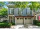 Charming two-story home features a two-car garage, complemented by lush greenery and a welcoming entrance at 2412 St Davids Sq # 16, Kennesaw, GA 30152