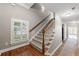 Hallway featuring hardwood floors, a carpeted staircase, and a window at 2412 St Davids Sq # 16, Kennesaw, GA 30152