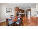 Open kitchen and dining space featuring stainless steel appliances, granite counters, and wooden table at 2412 St Davids Sq # 16, Kennesaw, GA 30152