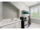 Well-equipped laundry room with sink, microwave, mini fridge and window at 2412 St Davids Sq # 16, Kennesaw, GA 30152