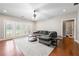Bright living room featuring hardwood floors, a comfortable sofa, and access to the outdoors at 2412 St Davids Sq # 16, Kennesaw, GA 30152
