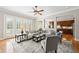Spacious living room with hardwood floors, large windows, comfortable seating, and kitchen access at 2412 St Davids Sq # 16, Kennesaw, GA 30152
