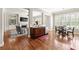 Open-concept living area with hardwood floors, fireplace, kitchen, and ample natural light at 2412 St Davids Sq # 16, Kennesaw, GA 30152