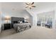 Spacious main bedroom featuring neutral carpet, ceiling fan, and large windows at 2412 St Davids Sq # 16, Kennesaw, GA 30152