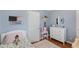 room with blue walls, wood floor, and a bed with a colorful floral comforter at 3841 Admiral Dr, Atlanta, GA 30341