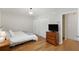 Simple bedroom features wood floors, a double closet, and a traditional wood dresser at 3841 Admiral Dr, Atlanta, GA 30341