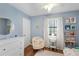 bedroom with blue walls, a ceiling fan, wood floor, and a chair next to a table at 3841 Admiral Dr, Atlanta, GA 30341