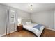 Neutral bedroom featuring a plush bed, hardwood floors, and natural light from the window at 3841 Admiral Dr, Atlanta, GA 30341