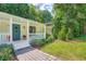 Charming home featuring a quaint front porch, blue door, and well-maintained landscaping at 3841 Admiral Dr, Atlanta, GA 30341