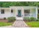 Inviting front porch with a swing, blue front door, and manicured landscaping, perfect for relaxing at 3841 Admiral Dr, Atlanta, GA 30341