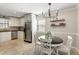 Eat-in kitchen featuring stainless steel appliances, white cabinets, and an adjacent dining area at 3841 Admiral Dr, Atlanta, GA 30341